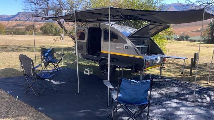 Camper trailer on grass with awning open
